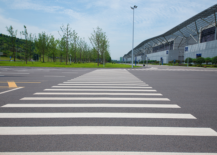 Commercial parking lot in Colorado with professional pavement markings, ADA parking spaces, directional arrows, and safety striping.