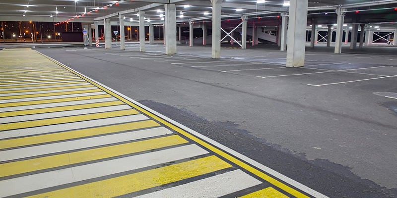 Freshly sealed commercial parking lot completed by Prime Line Company with premium asphalt maintenance services.