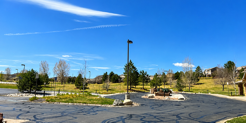 Prime Line Company crew applying professional asphalt sealcoating to extend pavement life in Denver, Colorado.