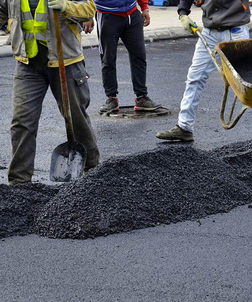 Freshly sealcoated asphalt roadway with a smooth black finish completed by Prime Line Company for long-lasting pavement protection.