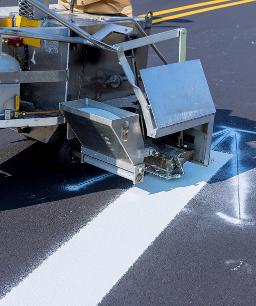 Prime Line Company applying professional asphalt sealcoating to protect and restore a residential roadway in Colorado.