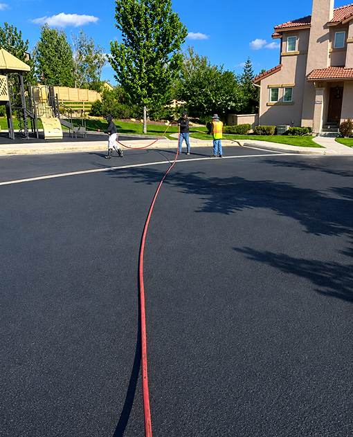 HOA community asphalt sealcoating improving pavement appearance and durability in Denver.