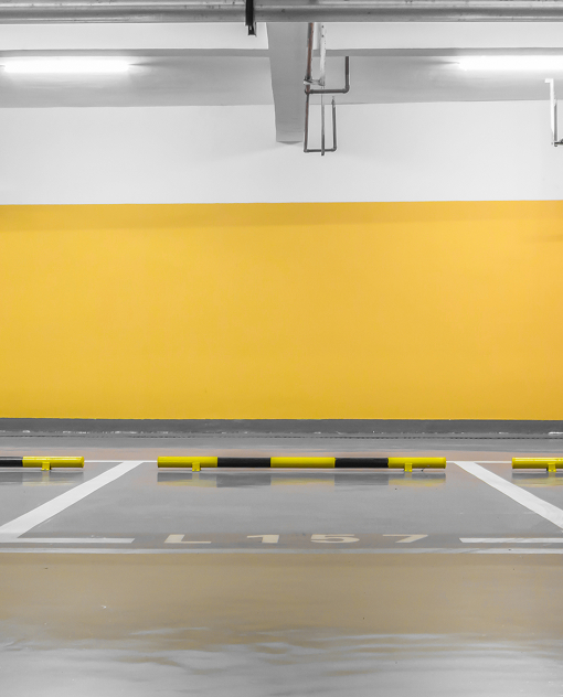 Warehouse parking lot striping with high-visibility traffic markings by Prime Line Company.